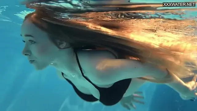 Blonde teen savoring naked swim in perfect body