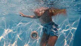 Blonde bombshell flaunts gigantic gazongas while splashing around in seductive slow-mo